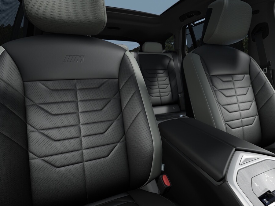 The front seats of the sample X5 in Black and Atlas Grey II M interior.